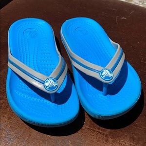 Crocs blue and grey flip flops